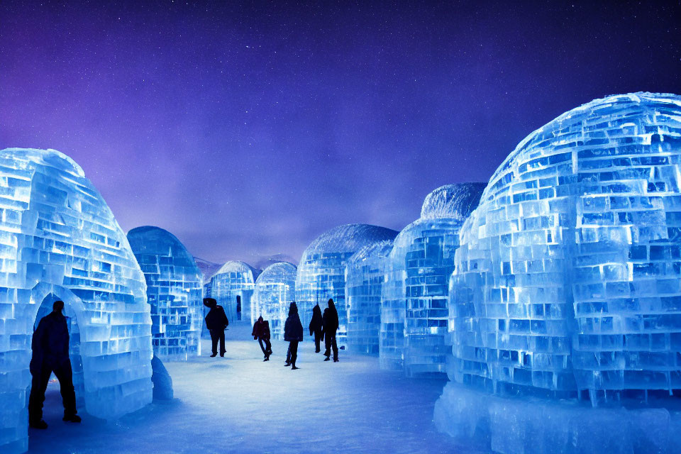 Illuminated ice village under starlit sky