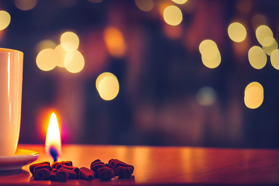 Soft Flame Candle Next to White Mug and Star-shaped Cookies on Wooden Surface