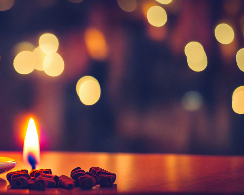 Soft Flame Candle Next to White Mug and Star-shaped Cookies on Wooden Surface