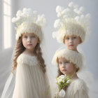 Two girls in flower crowns and elegant dresses with white roses, looking serene.