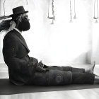 Bearded person in patterned suit and hat on yoga mat with book, surrounded by flowers and art