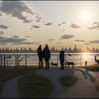 Group of People and Dogs by Lakeside Sunset Skyline View