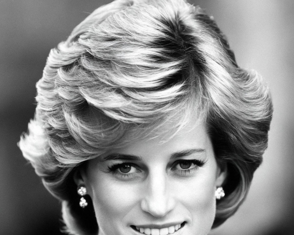 Monochrome image of woman with short styled hair and earrings