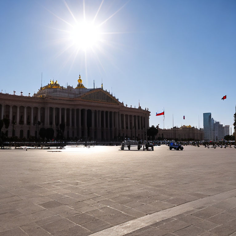 Sunlit Square with Grand Building and Golden Dome Against Blue Sky