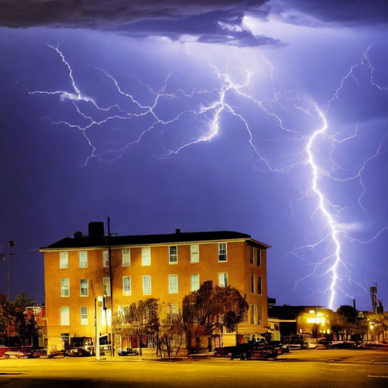 Vibrant lightning bolt in night sky over brick building