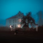 Cozy house in nighttime forest with lit windows