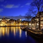 Luminescent waterside village with glowing fish boat at night