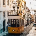 Vintage Tram on Cobblestone Street with Pastel Buildings