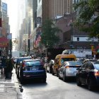 Rainy Urban Street Scene with Vintage Cars and Lights