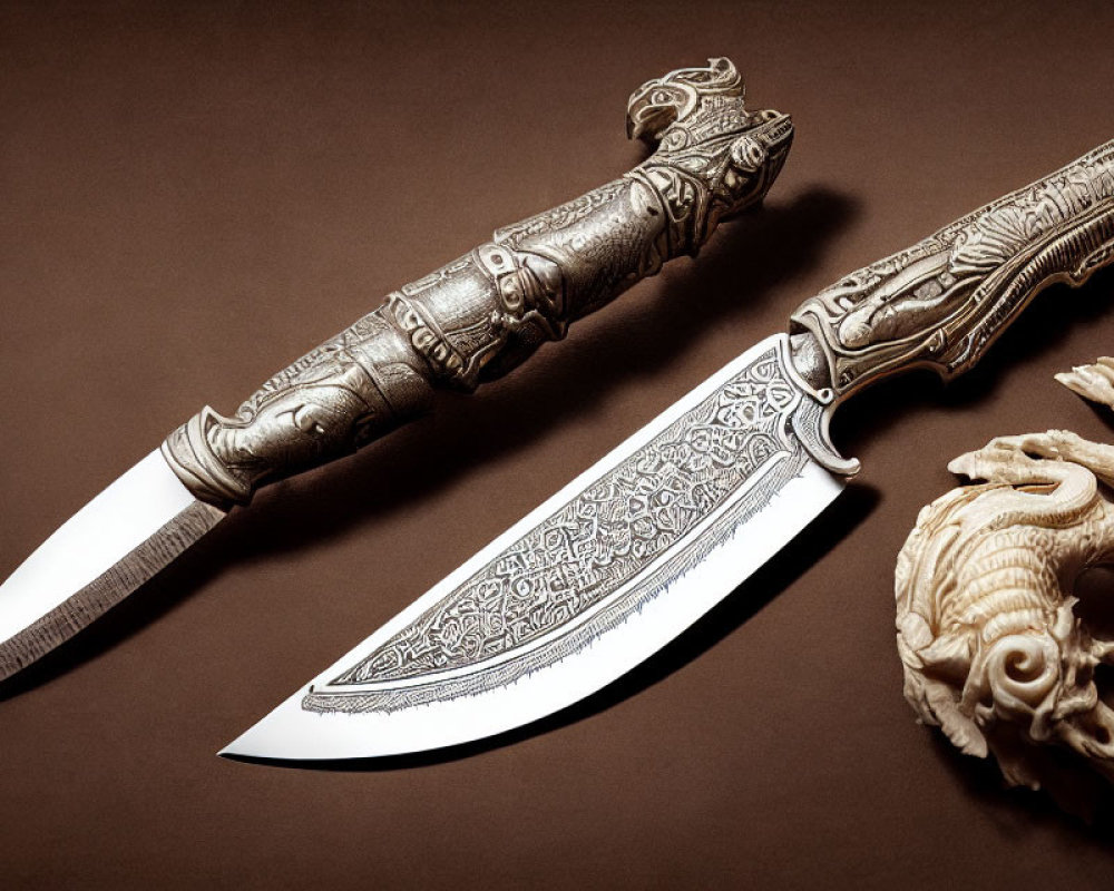 Intricately carved knives with detailed designs on blades and handles