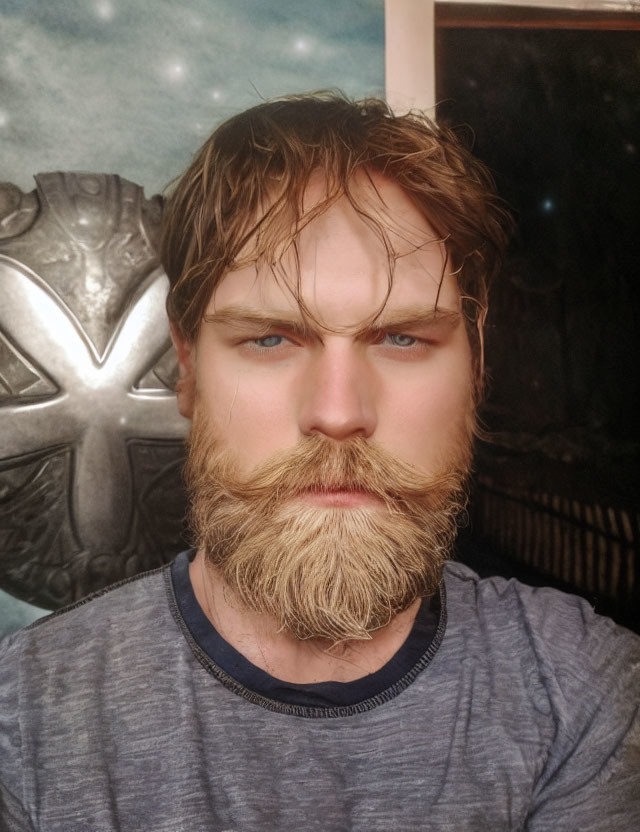 Intense man with thick beard and crest emblem in background