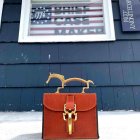 Rusty vintage water tap on red block against weathered white window frame