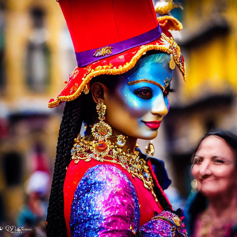 Vibrant blue face paint and golden headgear on person in purple outfit