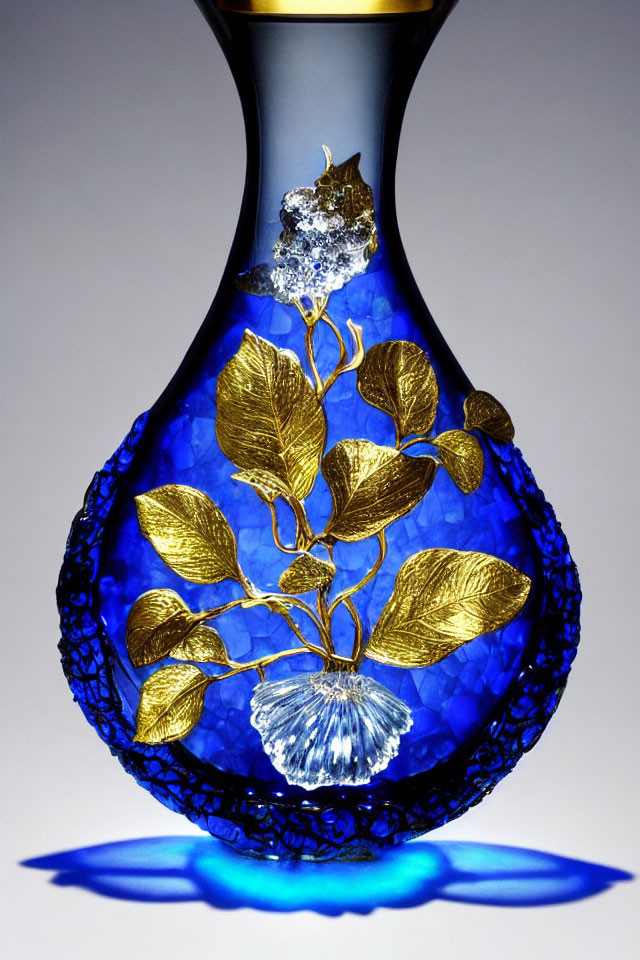 Blue Glass Vase with Gold Leaf Accents and Floral Design on Light Surface