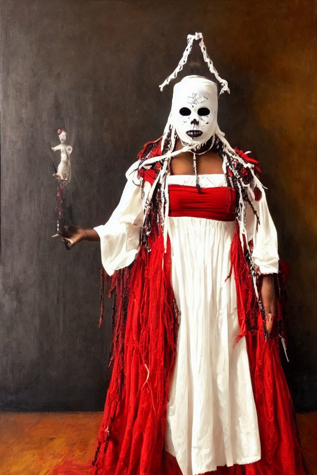 Person in white and red robe with skull-like mask holding small figure in dark background