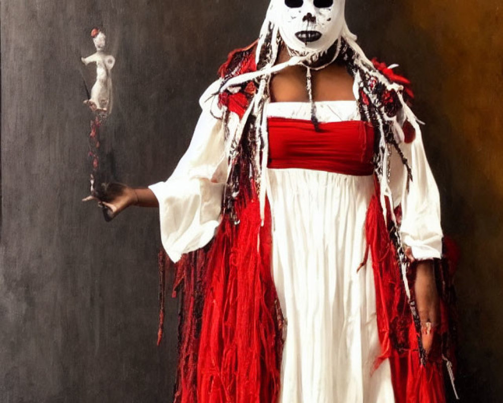 Person in white and red robe with skull-like mask holding small figure in dark background