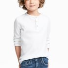 Realistic painting of young child with curly hair in white shirt and jeans