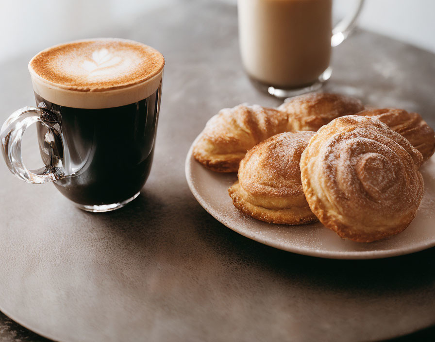 Cappuccino with Latte Art, Milk, and Pastries on Table