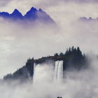 Person overlooking waterfall and mountain peaks.