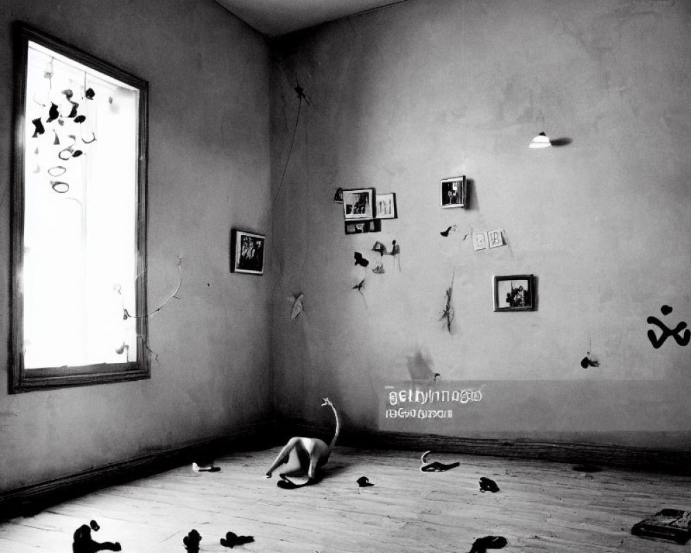 Surreal monochrome room with scattered shoes and floating pictures