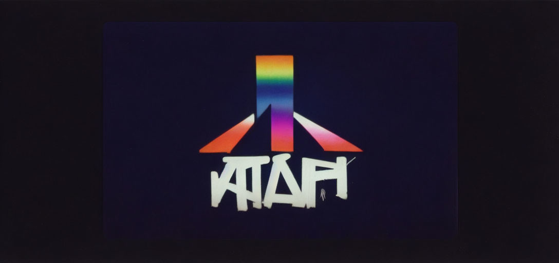 Rainbow-colored retro Atari logo on black background with stylized white text