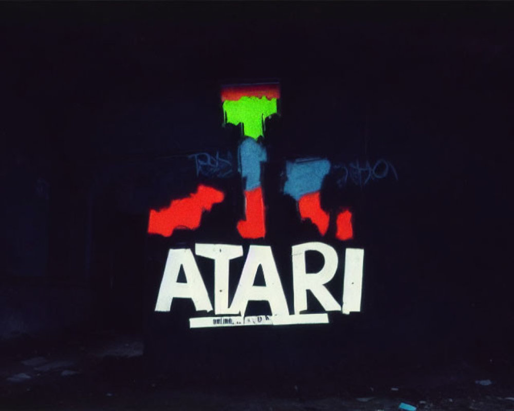 White "Atari" logo graffiti on dark background with colorful paint splashes and bright window.