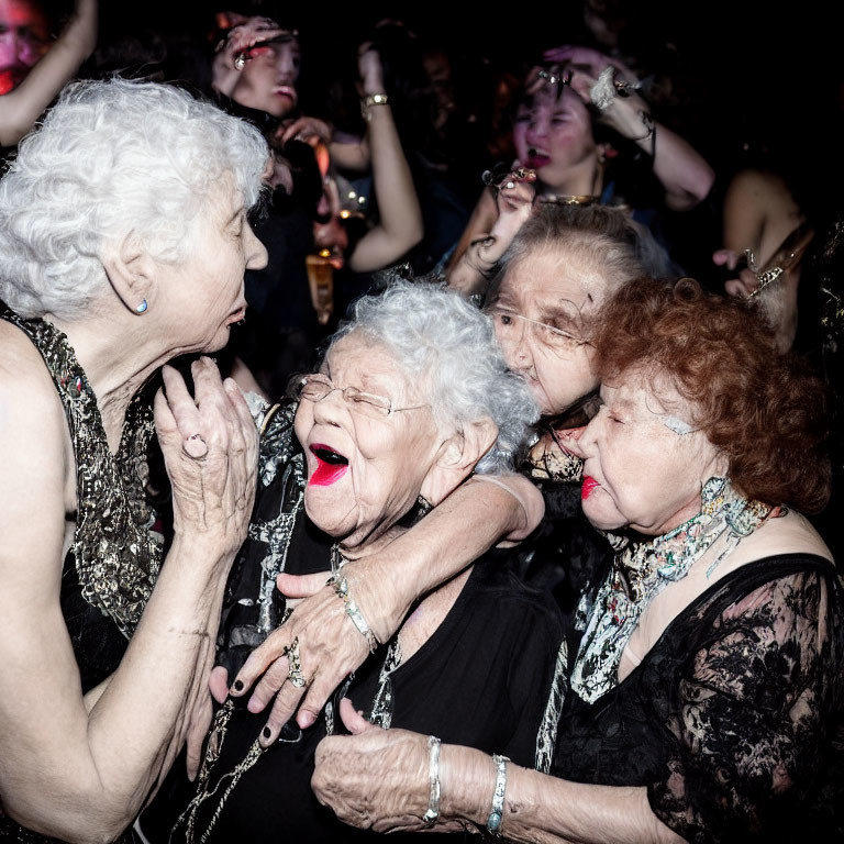 Elderly women dancing and embracing at lively party