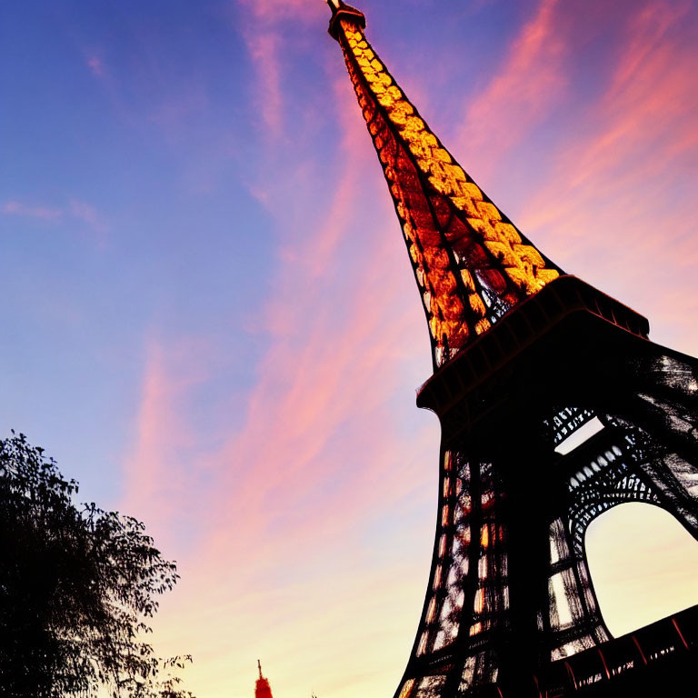 Iconic Eiffel Tower at dusk with vibrant pink and blue sky