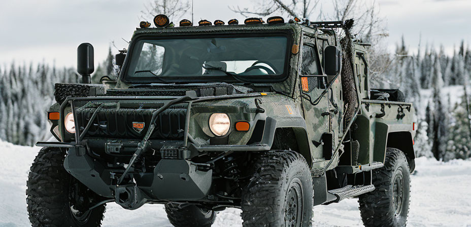 Military-grade Humvee with off-road tires in snowy landscape