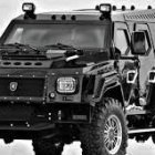 Military-grade Humvee with off-road tires in snowy landscape