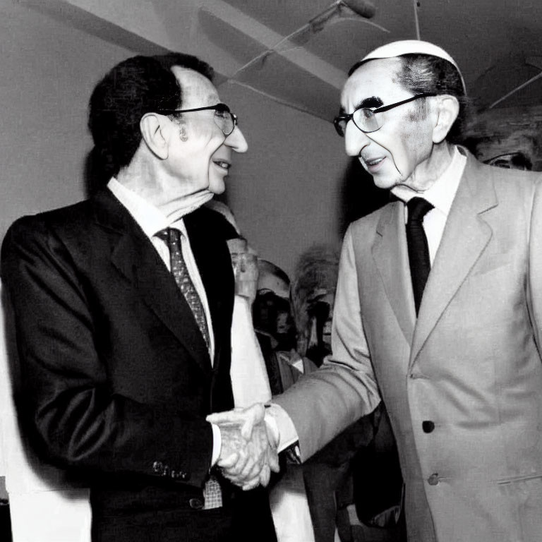 Elderly Men in Black and White Photo Smiling and Shaking Hands