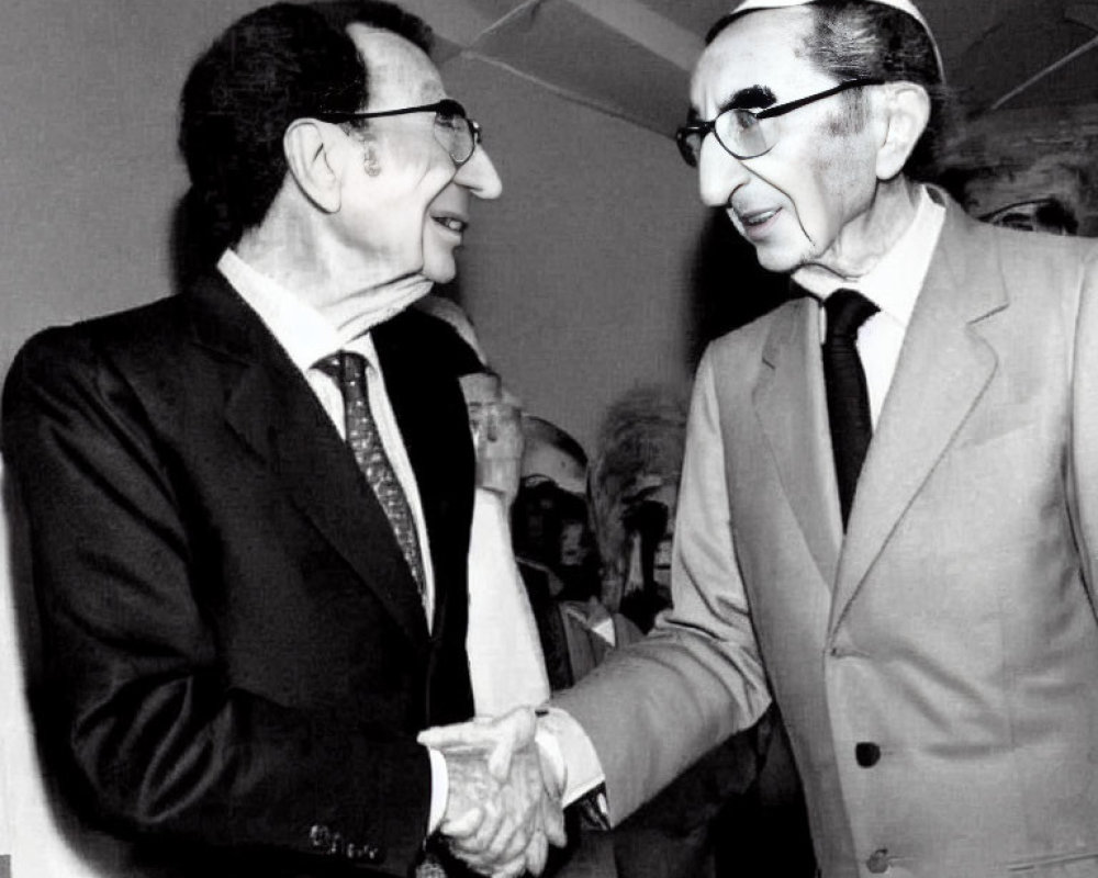 Elderly Men in Black and White Photo Smiling and Shaking Hands