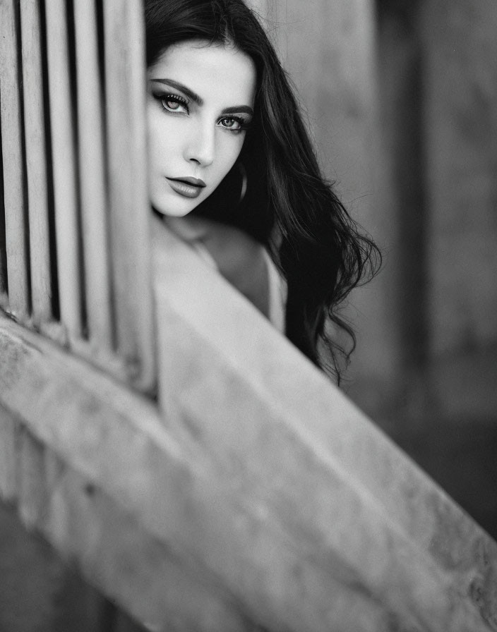 Monochrome portrait of a woman with striking eyes and dark hair.