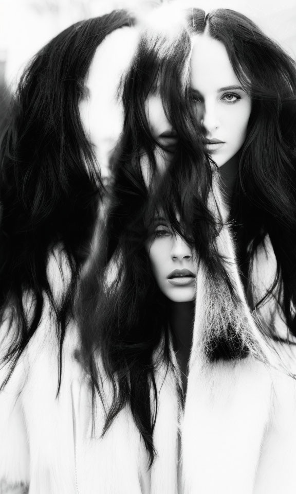 Monochrome image of two women with flowing dark hair in intense gaze