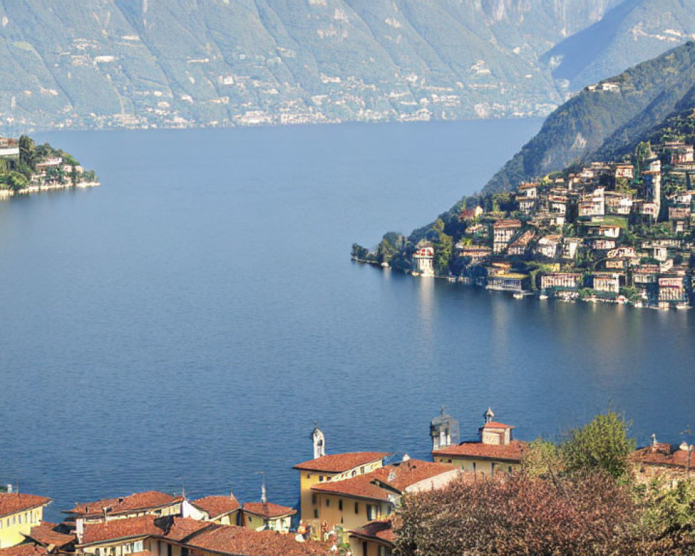 Tranquil Lake and Colorful Buildings in Lush Green Hills