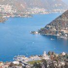 Tranquil Lake and Colorful Buildings in Lush Green Hills