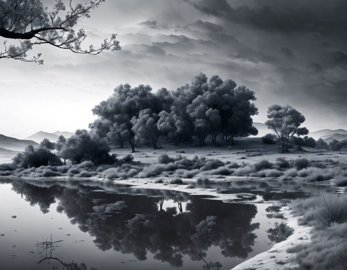 Tranquil monochrome landscape with trees, lake reflection, mist, hills, and cloudy sky