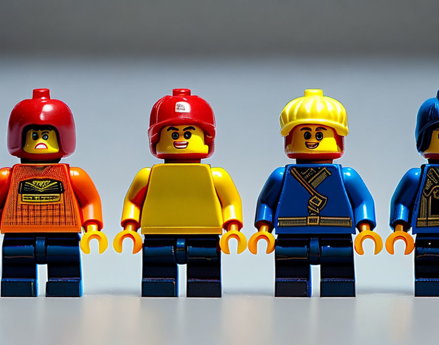 Four Lego minifigures in different outfits and hats depicting characters and professions.