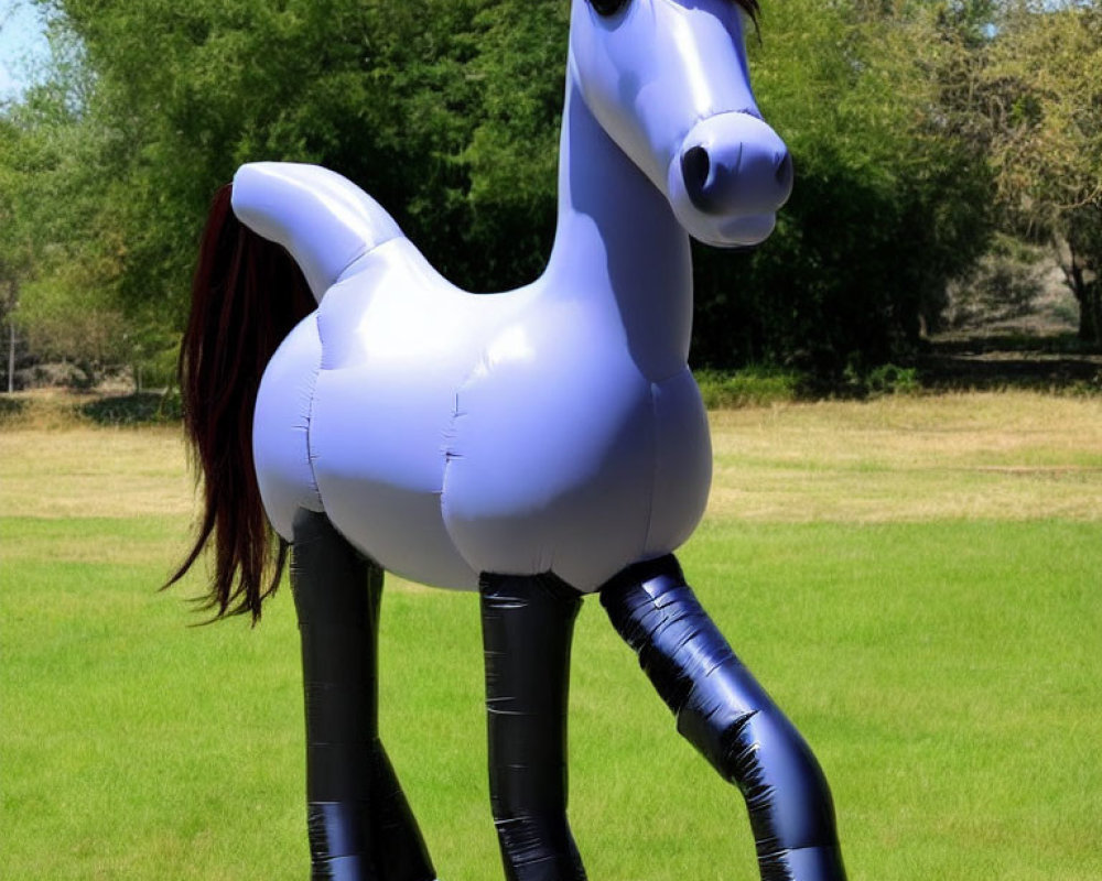 Purple Inflatable Horse with Black Hooves and Dark Mane in Grassy Area