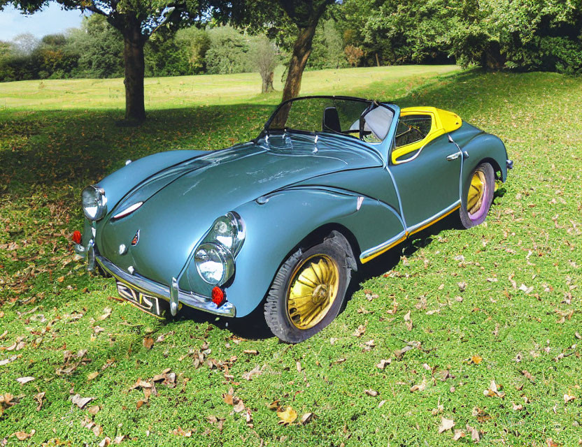 Classic Two-Tone Convertible Car with Yellow Wheels on Grass Field