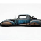 Vintage Teal Car with Streamlined Design and Rust Spots on White Background