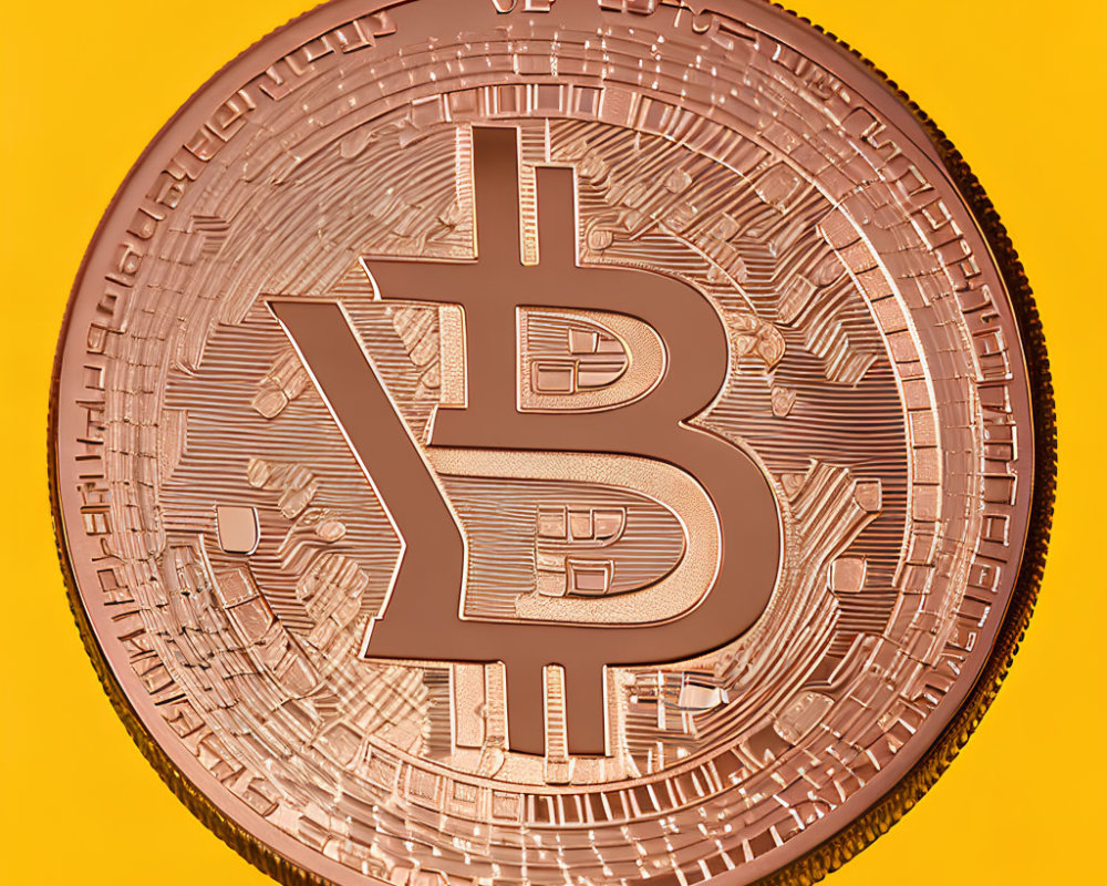 Detailed Bronze Bitcoin Token on Vibrant Yellow Background