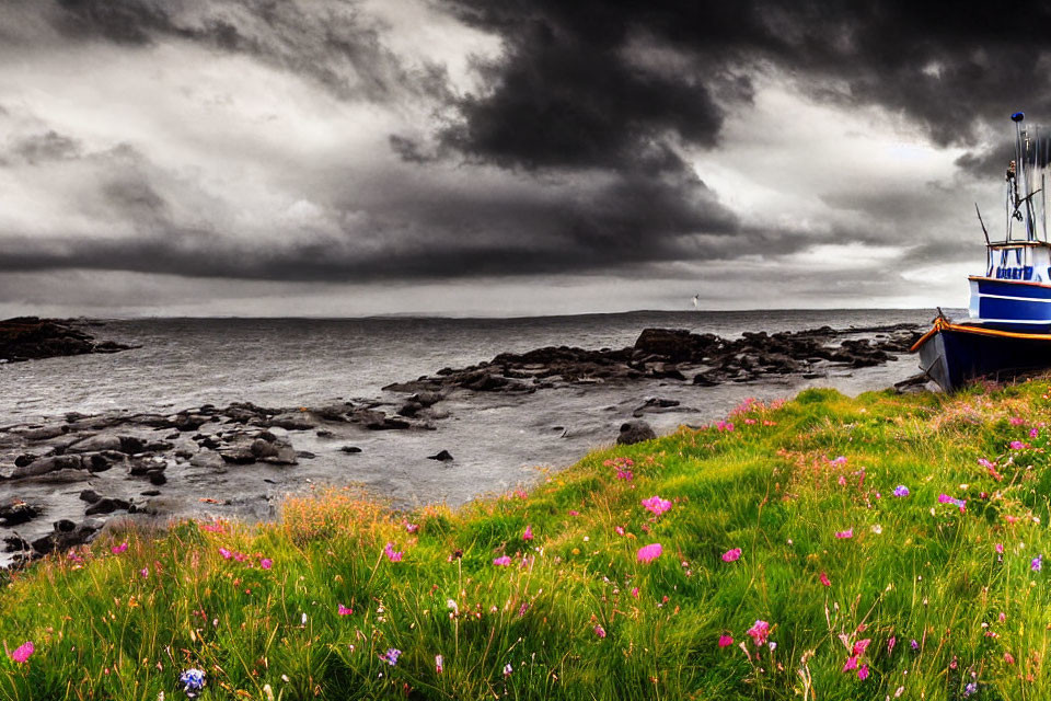 Fishing boat near rocky shoreline under stormy sky with wildflowers.