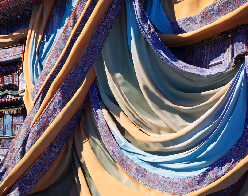 Blue and Gold Draped Fabrics with Intricate Patterns