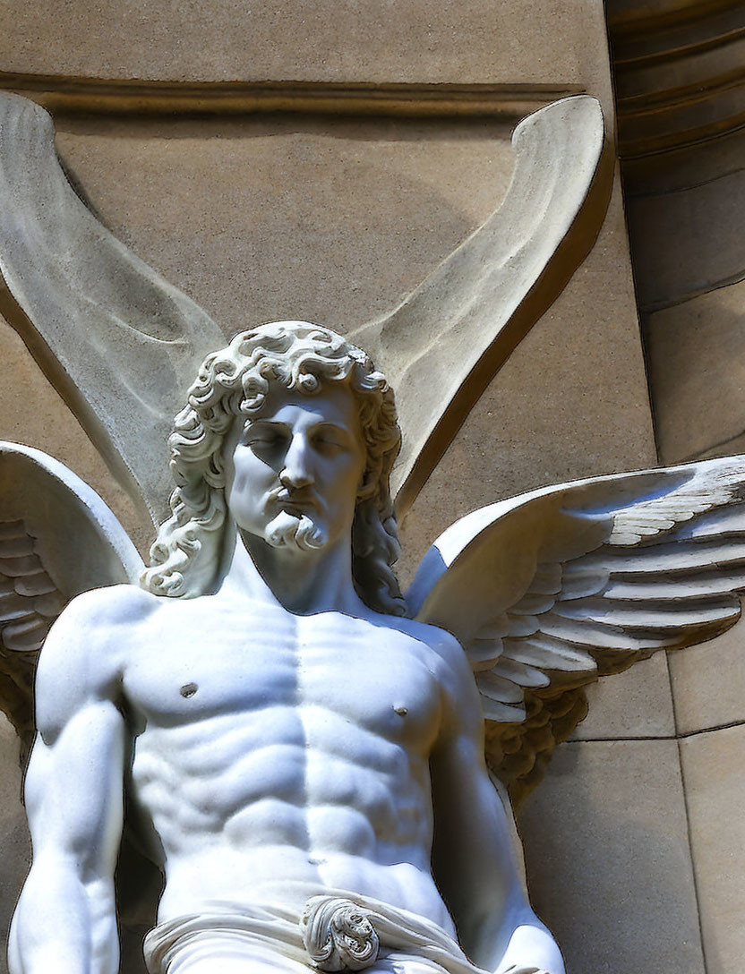 Angel sculpture with curly hair and detailed wings against stone building background