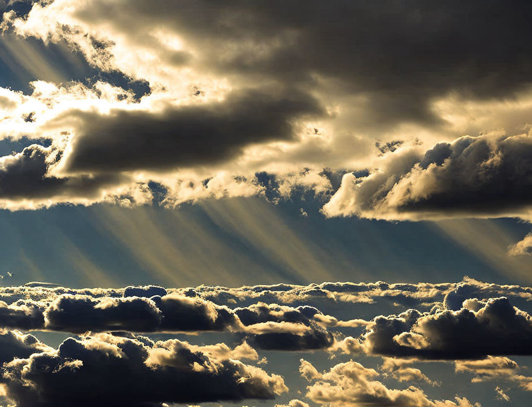 Dramatic sunrays through dark clouds create striking light pattern