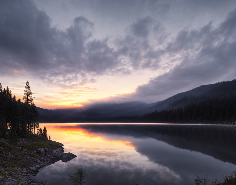 Serene Sunrise Scene: Lake, Cloud Reflections, Forest, Mountains