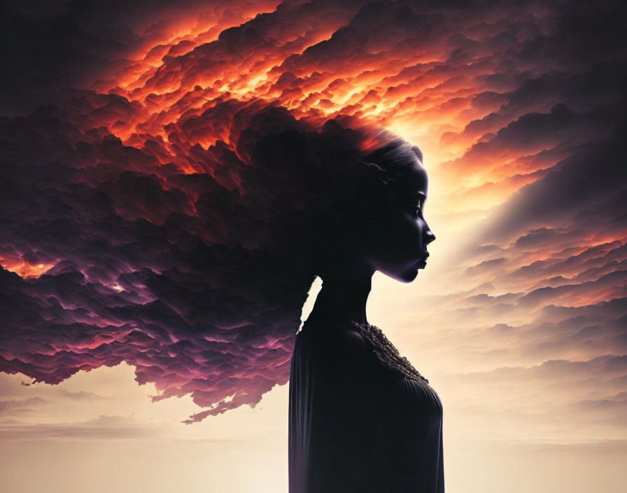 Woman's profile silhouette against dramatic fiery sky