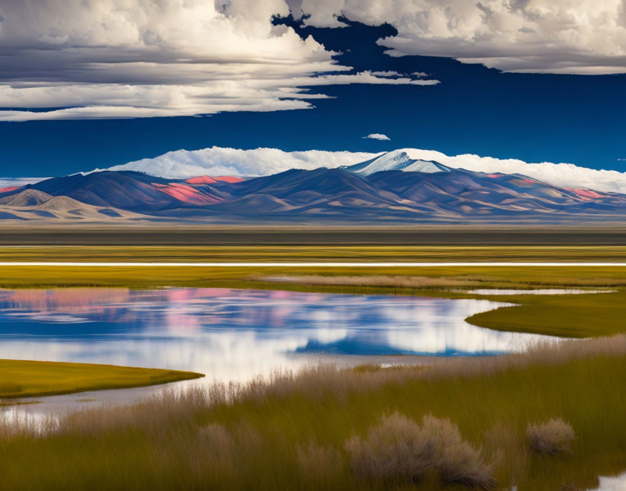 Serene high-altitude lake with snow-capped mountains and golden grasses