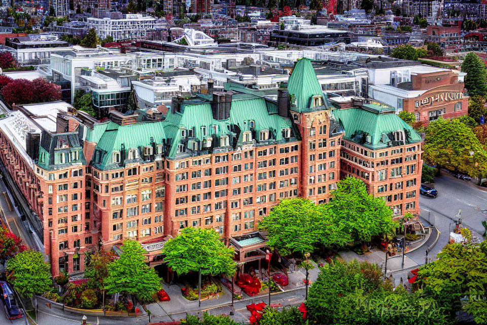 Historic red-brick hotel with green copper roofs in vibrant HDR.